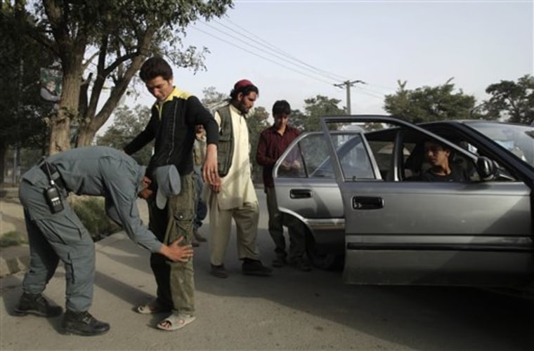 Policemen frisk commuters at a checkpoint set up as a security measure a day ahead of parliamentary elections in Kabul, Afghanistan, Friday Sept. 17, 2010. Afghanistan will elect the lower house of its parliament on Sept. 18. (AP Photo/Saurabh Das)